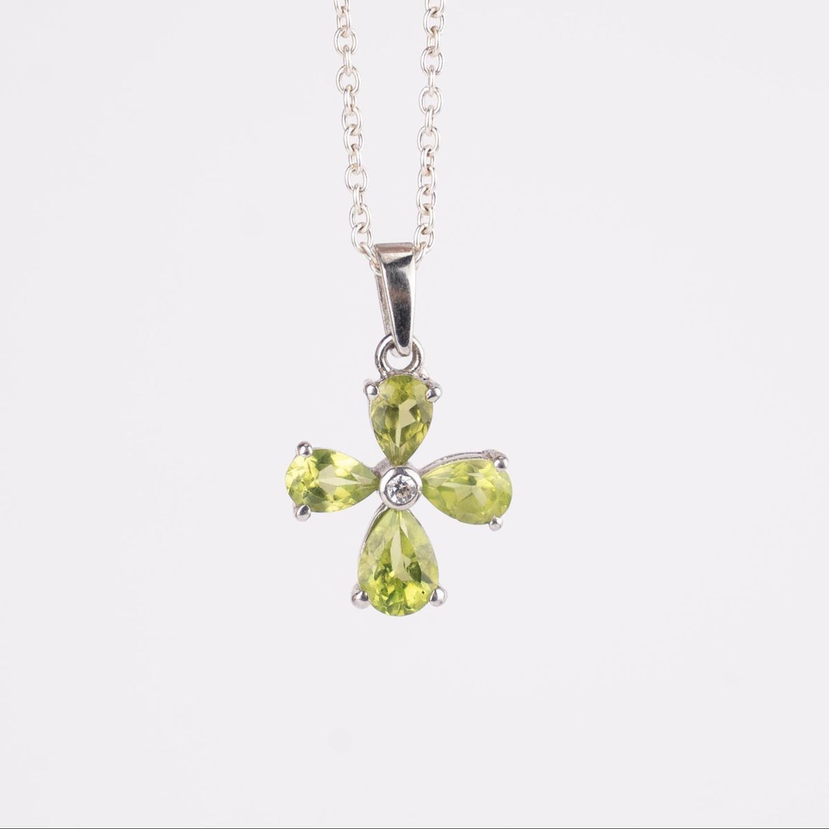 Green gemstone pendant on a white background