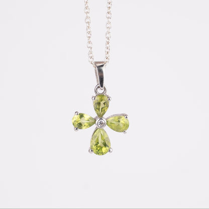 Green gemstone pendant on a white background