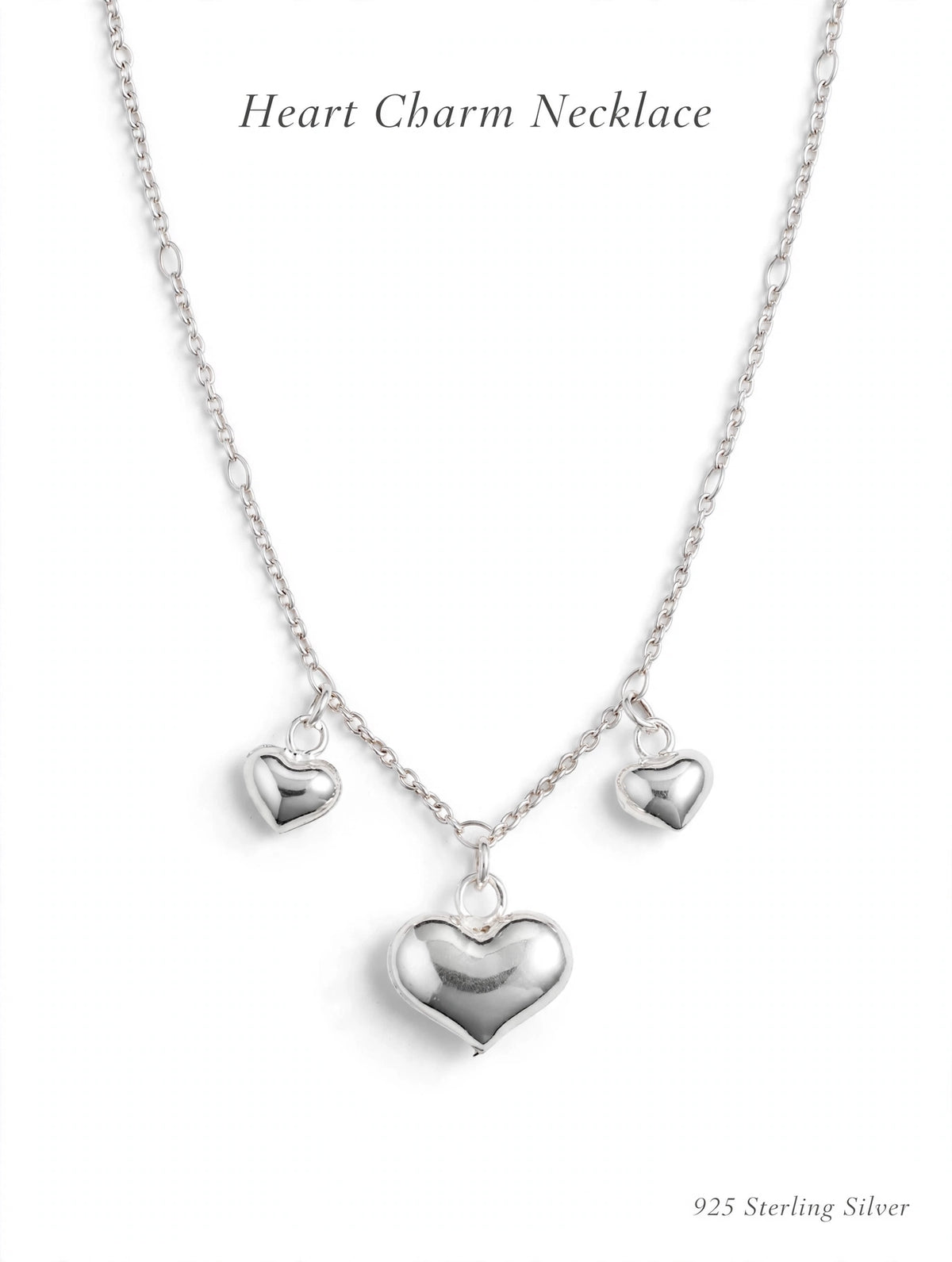 925 sterling silver heart charm necklace with three puffy heart pendants on white background