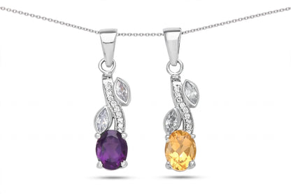 A pair of silver pendant necklaces on a fine silver chain, featuring oval purple and yellow gemstones with marquise-cut clear accent stones, shown against a plain white background.